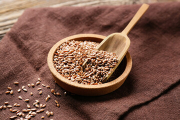 Plate and scoop with flax seeds on table