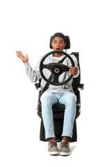 Stressed African-American man in car seat and with steering wheel on white background
