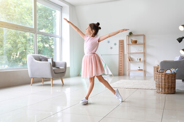 Adorable little ballerina dancing at home