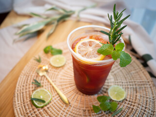 Homemade ice lemon tea with mint and rosemary