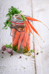 Preparation for pickled carrots with garlic, bay leaf and dill.