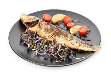 Plate with delicious sea buss fish and vegetables on white background