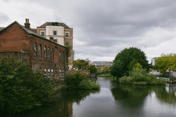 Fototapeta na wymiar Houses by Kennet River in town centre of Reading, United Kingdom