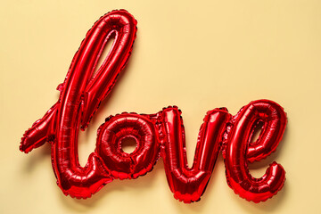 Balloon in shape of word LOVE on beige background. Valentine's Day celebration