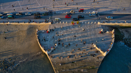Aerial drone view of Commerce Square port. People chillin at winter sunset in Lisbon, Portugal