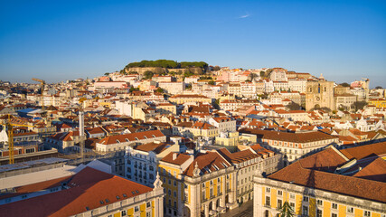 Fototapeta na wymiar Lisbon, Portugal - January 13, 2022: Aerial drone view of Commerce Square in Lisbon, Portugal. Sao Jorge Castle in the background. Winter sunset.