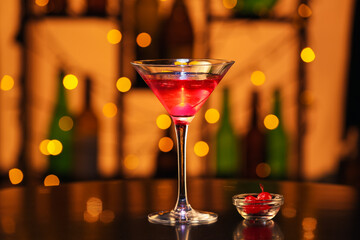 Glass of tasty Manhattan cocktail on table in bar