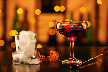 Glass of tasty Manhattan cocktail on table in bar
