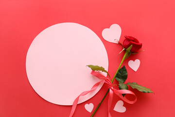 Composition with blank card, rose flower and paper hearts on red background. Valentine's Day...
