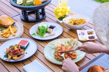 woman is eating Thai food at restaurant