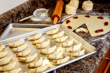 Making raw croissant cookies stuffed with marmalade.