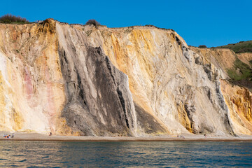 View of multicoloured sand cliffs in Alum Bay, near the Needles, in Isle of Wight, United Kingdom