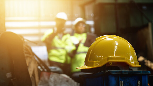 Yellow helmet in Industrial engineer and businessman in safety helmet working in factory, planning, discussing and training workers with tablet in metalwork place , teamwork and team concept