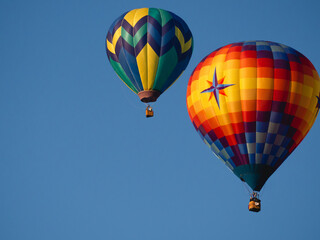 Fototapeta na wymiar Hot Air Balloons Floating in Clear Blue Sky