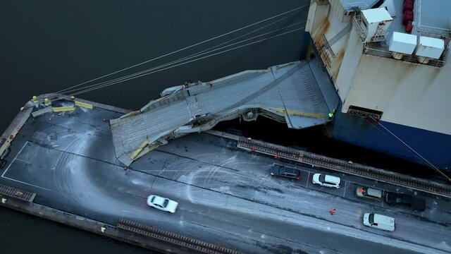 Aerial  View of Vehicles Being Unloaded and Loaded onto a Vehicle Carrier Ship 
