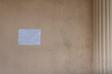 Blank white paper for banner sticked on old and dirty concrete wall