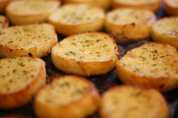 Several garlic breads being baked in the oven