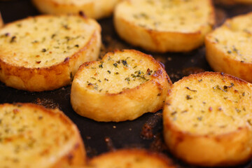 Several garlic breads being baked in the oven