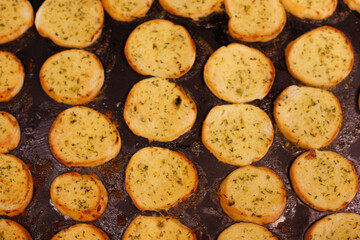 Several garlic breads being baked in the oven