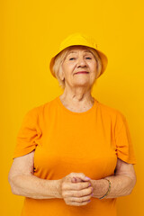 Portrait of an old friendly woman happy lifestyle in a yellow headdress close-up emotions