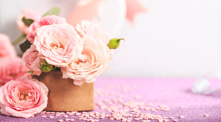 A bouquet of delicate pink roses. Festive card with pink flowers on a light background, copy space for text