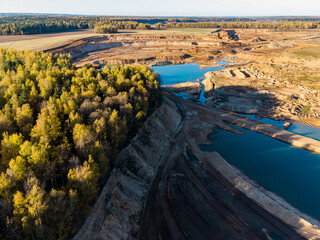 Surviving forest area on the border with the development of a large sand pit, aerial view