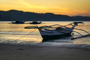 Sunrise at a fishing village, Oriental Mindoro. Traditional net fishing for small fish. An environmental and ecological disaster. 