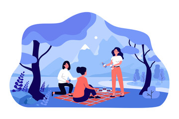 Fototapeta premium Female friends meeting for picnic on river beach in forest