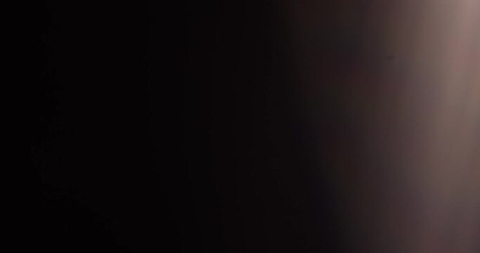 Shimmery light leaks on black background. Lens flare burst overlays with bokeh effect.