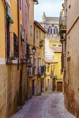 Old houses in a picturesque alley in the medieval city of Toledo, Spain.