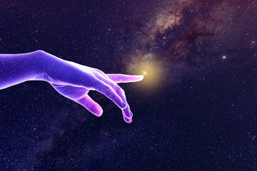 Hand of God universe creation concept. A sparkling star covered purple and pink lit hand points to...