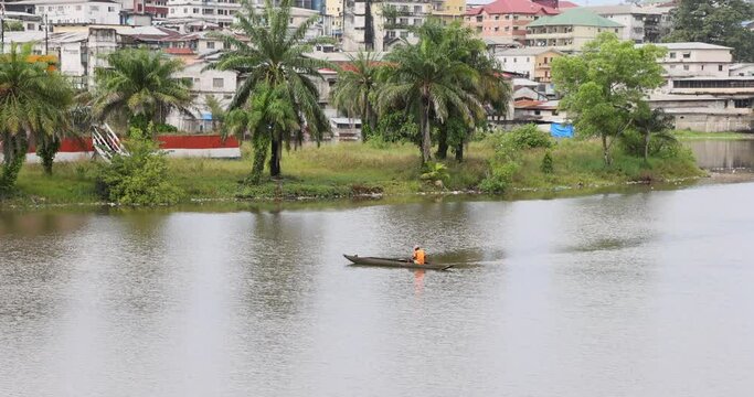 Dugout wood canoe ocean bay Monrovia Liberia. Coast of west Africa suffers extreme poverty and hunger. Pollution and filth on most ocean beaches shores. Tropical climate environment.