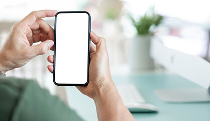 Closeup view of asian man holding in hands smartphone with empty blank mockup screen for advertising, using mobile apps. Remote e learning, online work, e commerce.