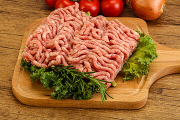 Raw pork minced meat over board