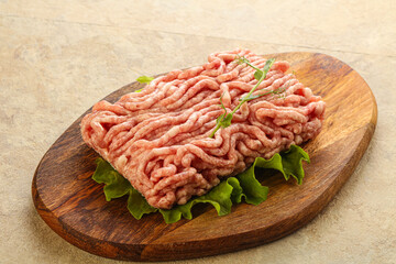 Raw minced pork meat over board