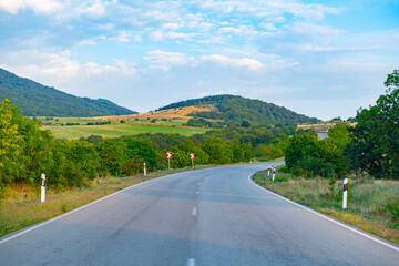 Obraz premium scenic asphalt road towards the mountains goes