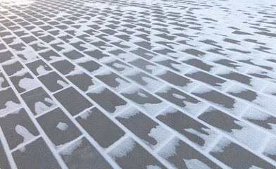 Fototapeta premium Paving slabs in the snow in winter.