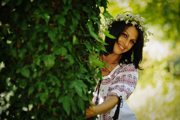young woman picking wildflowers to make a wreath.