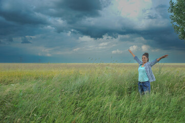 Naklejka na ściany i meble beautiful girl posing in a wheat field.