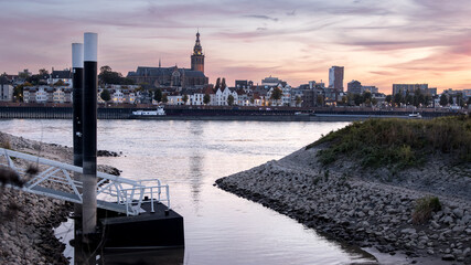 Quay wall in front of river with skyline of Nijmegen