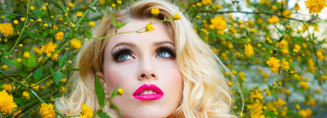Spring woman face for banner. Bright make-up woman at blossom field. Blond girl with professional...