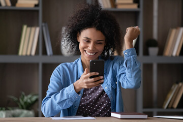 Happy joyful smartphone user excited with good news, reading message on mobile phone screen,...