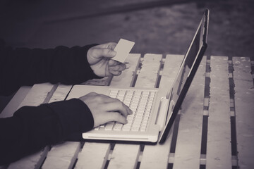 Anonymous hacker using laptop for stealing personal data from internet.