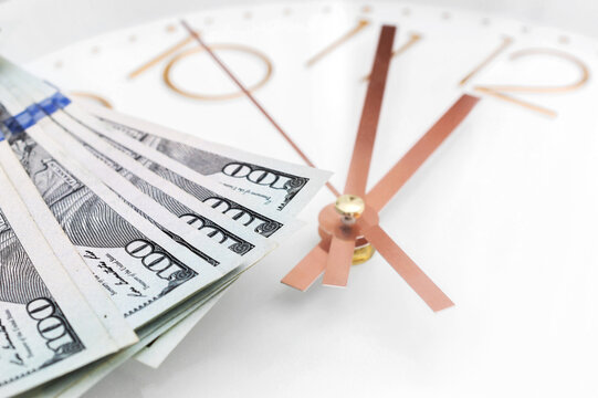 Money on the white clock face. Close up. Business concept.