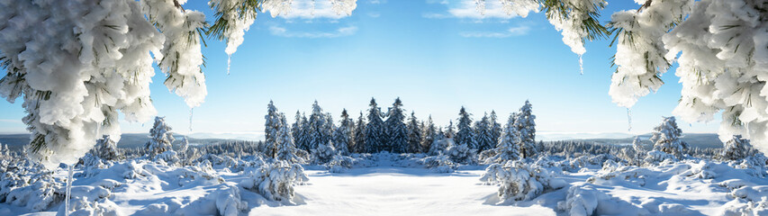 Fototapeta na wymiar Stunning panorama of snowy landscape in winter in Black Forest - Snow view winter wonderland snowscape background banner with frozen trees, icicle blue sky and sunshine