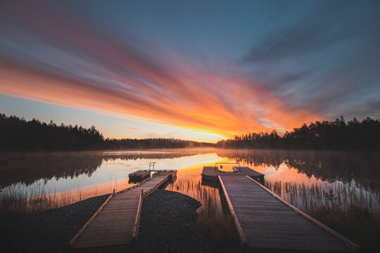 breathtaking sunrise at Lake Jatkonj&auml;rvi, which is coloured red, orange, purple, pink and blue by the sun. A mist clings to the surface of the lake, adding to the drama. Hossa national park, Finland
