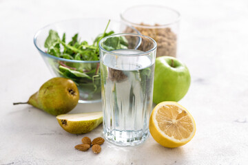 Food set for diet and healthy food. Glass of clear water with fruits, granola and salad bowl. Healthy breakfast