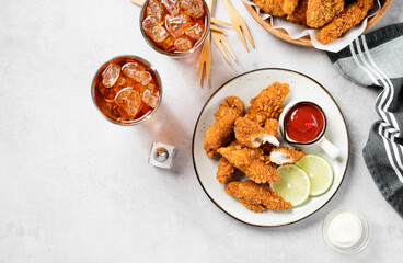 Delicious crispy fried breaded chicken breast strips with ketchup.	top view	