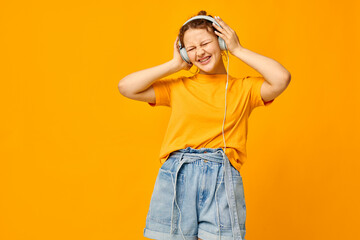 portrait of a young woman wearing headphones denim shorts close-up emotions cropped view unaltered