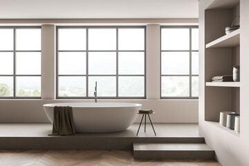 Naklejka na ściany i meble Light bathroom interior with bathtub on concrete podium, shelf and window